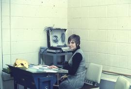 IMC staff member in front of a phonograph machine : [photograph]