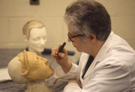 Photograph of a Funeral Services student working on a mannequin