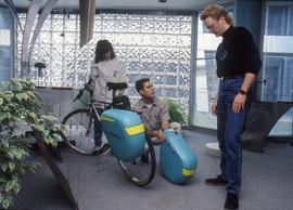 Photograph of students discussing bicycle saddle bags