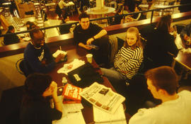 Photograph of Tracy Boyer in the Pipe cafeteria with friends