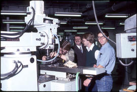 Photograph of Students Watching Someone Use a Milling Machine