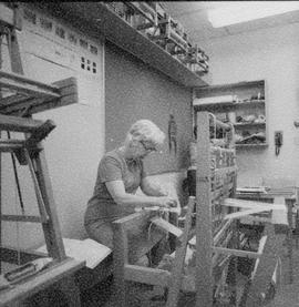 Photograph of an Older Woman Using a Loom