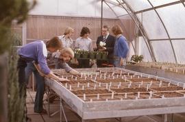 Students and staff in plant nursery : [photograph]