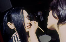 Photograph of makeup artist and model at fashion event