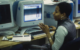 Photograph of a student at the computer working on assignment