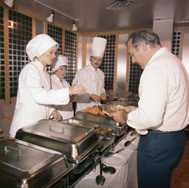 Photograph of staff serving a single guest