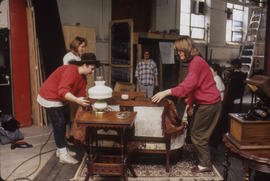 Photograph of students dressing a set and rehearsing