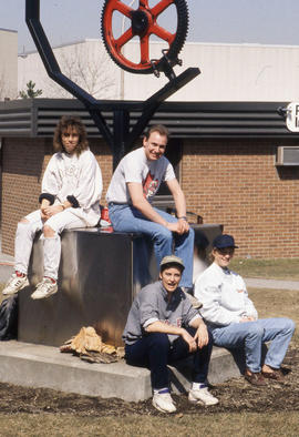 Photograph of Students Sitting on the Neil C. Shepherd Sculpture