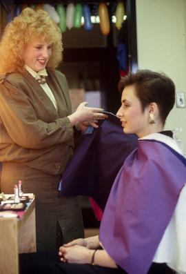 Photograph of student and a client in the makeup studio