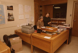 Photograph of staff examining paperwork at desk