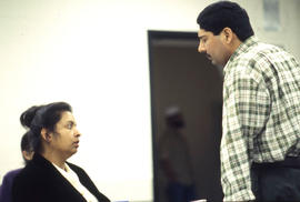 Photograph of student having a discussion with a faculty member in a COBOL programming class