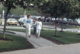 Photograph of students walking to the college entrance