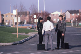 Photograph of students talking in a Humber College parking lot