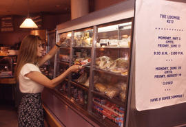 Photograph of staff grabbing food from the staff lounge