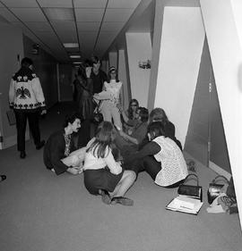 Photograph of Students Sitting in the "E" Building Hallway