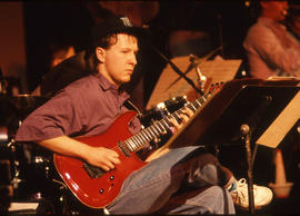 Photograph of a student musician playing a guitar