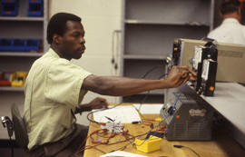 Photograph of student working on electronic equipment