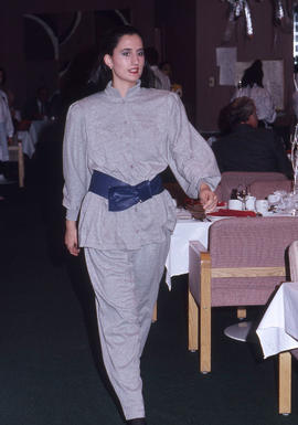 Photograph of a fashion model in a dining room