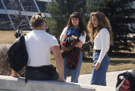 Photograph of Three Students Talking Outside