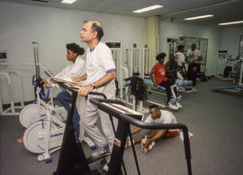 Photograph of people on various fitness equipment