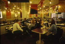 Photograph of Tracy Boyer in the Pipe cafeteria with friends