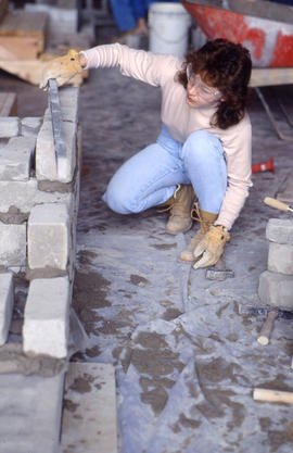 Photograph of a landscaping student constructing a garden display