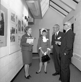 Photograph of visitors viewing Creative Arts displays in a D building hallway