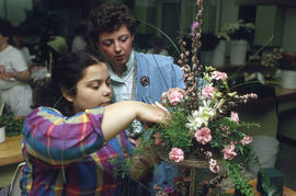 Photograph of unknown persons creating a floral arrangement