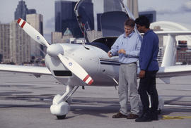 A photograph of a Flight Aviation faculty member instructing a student