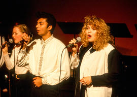 Photograph of a vocal trio performing at a concert
