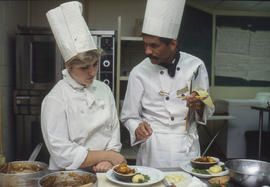 Photograph of students preparing food to serve in the Humber Room