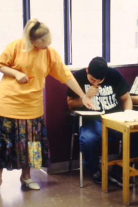A photograph of a faculty member helping a student