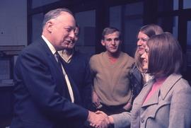 Gordon Wragg shakes a hand of a student : [photograph]