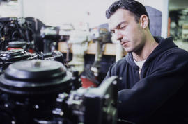 Photograph of a student working on a small machine