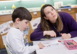 Photograph of an Early Childhood Education student working with a child
