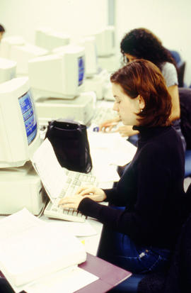 A photograph of two Pharmacy Assistant students working in a computer lab