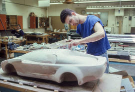 Photograph of an Industrial Design student working on his design