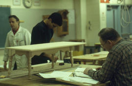 Photograph of faculty member Mark Paddison and students in the woodworking lab