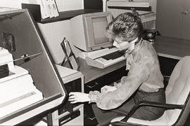 Photograph of a word processing operator at her desk