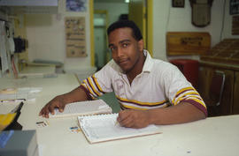 Photograph of a Staff Member Sitting at the Front Desk at the Athletic Centre