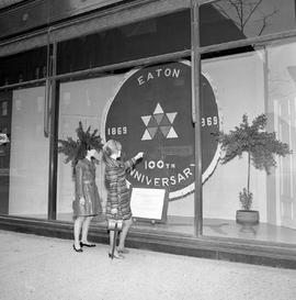 Photograph of the Eaton 100th Anniversary carpet on display in a main window of a department store