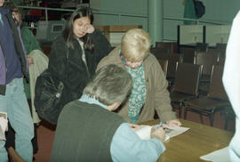 Photograph of Wayson Choy signing books