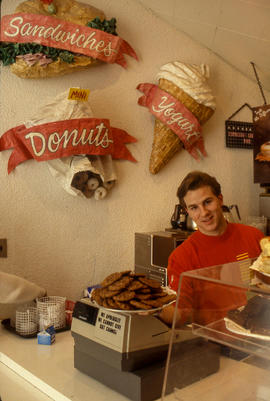 Photograph of an attendant at a coffee and snack shop