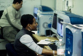 Photograph of two students in the journalism lab