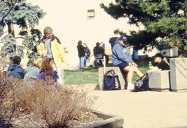Photograph of students seated outdoors on benches