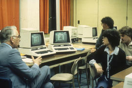 Photograph of a Faculty Member with Students in the PET Computer Lab