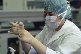 Photograph of a Pharmacy Assistant Student Preparing a Syringe