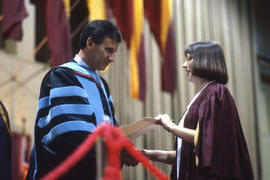 Photograph of a Graduate student receiving a Diploma