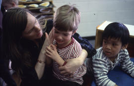 Photograph of an Early Childhood Educator attending to children