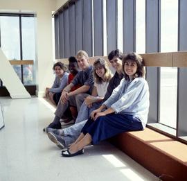 Photograph of students seated on a window ledge